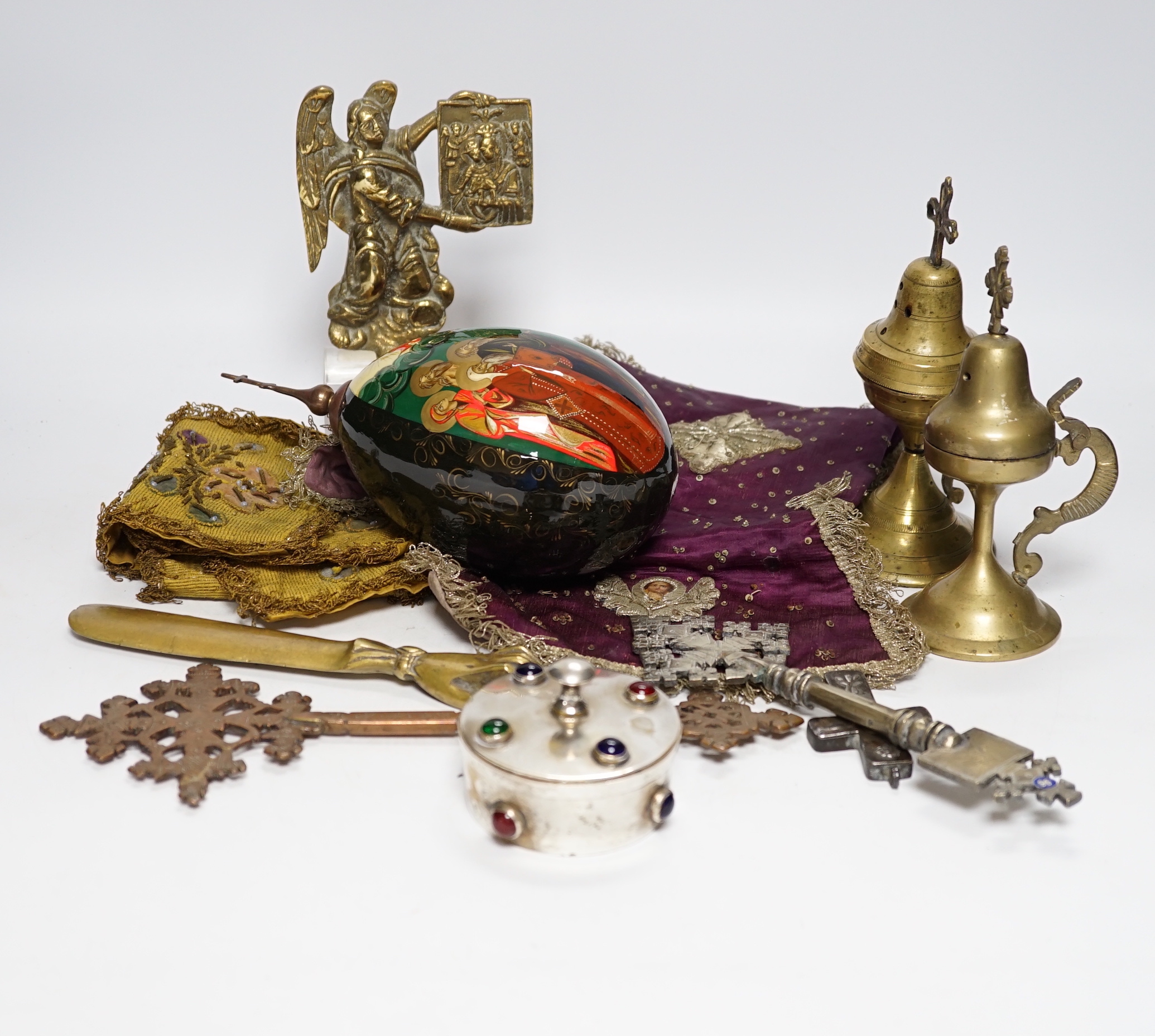Coptic Christian items including crosses, censers, a brass angel, two embroidered chalice covers, a large painted egg with orthodox cross on the top, a lidded patten box, etc. (11)